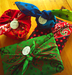 four packages wrapped in bandannas