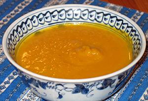 deep golden soup in blue and white china bowl