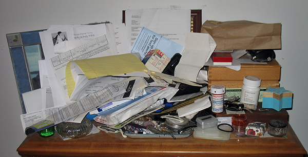 cluttered bureau surface